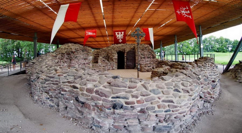 Ruiny Palatium na Ostrowie Lednickim. Powiewają flagi Polski i z Orłem Piastowskim. 